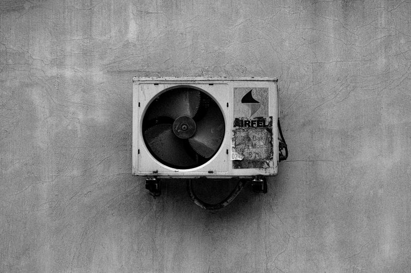 Technician servicing an air conditioning unit