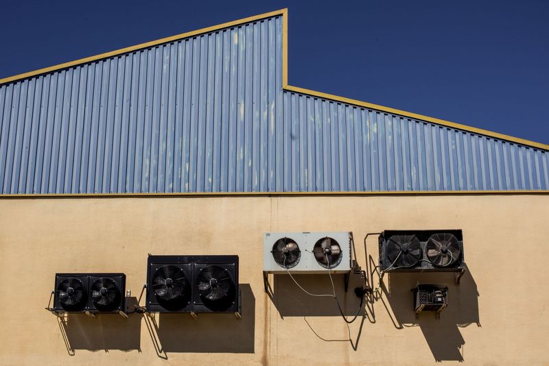 Outdoor air conditioning condenser installed beside a home