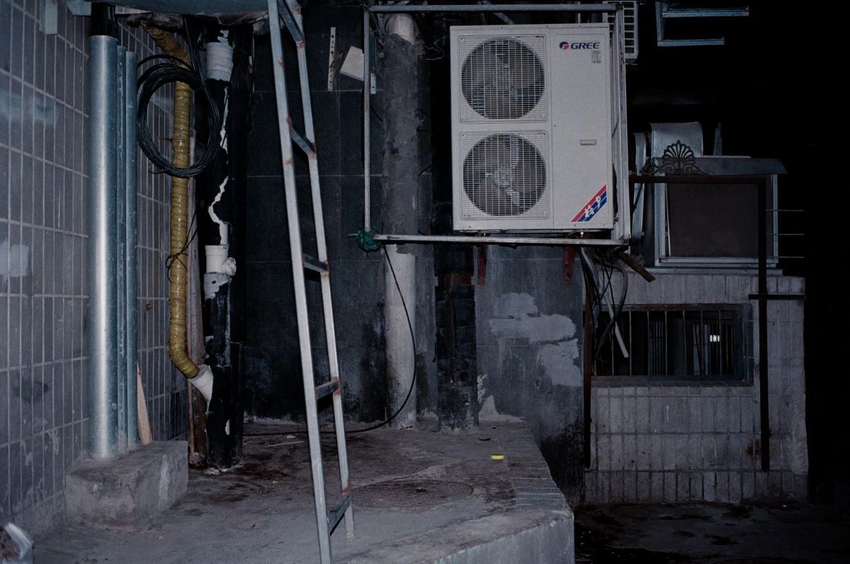 Summit Comfort technician servicing an outdoor air conditioning unit at a Missouri home